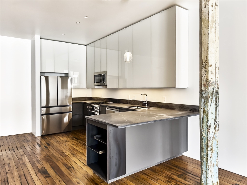 a kitchen with a stove sink and refrigerator