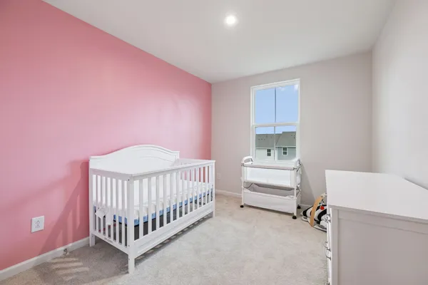 a bedroom with a bed and window