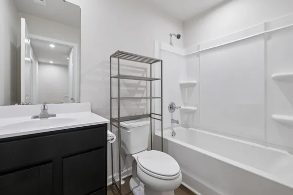a bathroom with a sink toilet vanity and shower