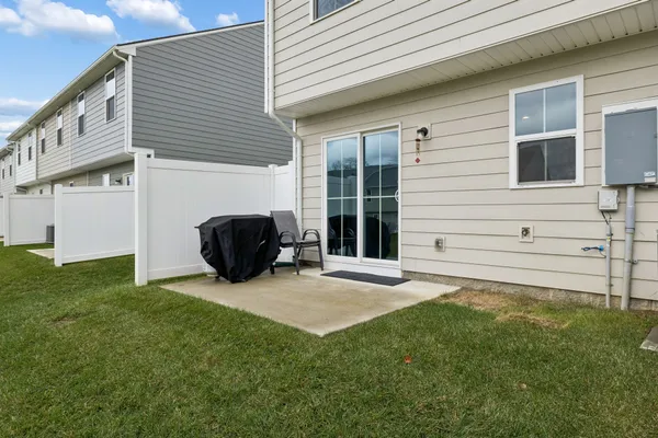 a view of a house with backyard and sitting area