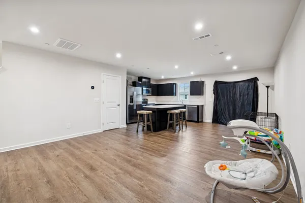 a large kitchen with a table and chairs