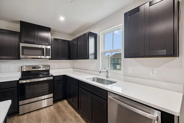 a kitchen with a sink stainless steel appliances and cabinets