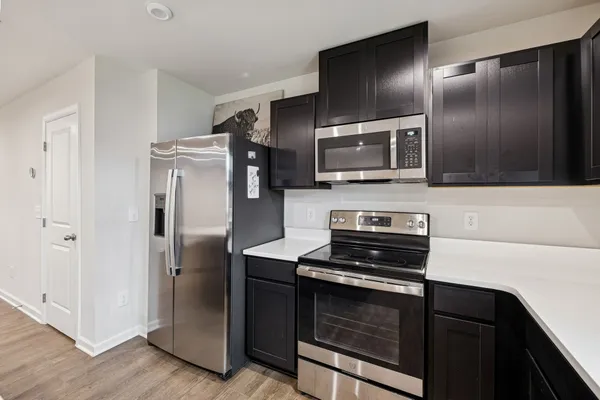 a kitchen with a refrigerator stove and microwave