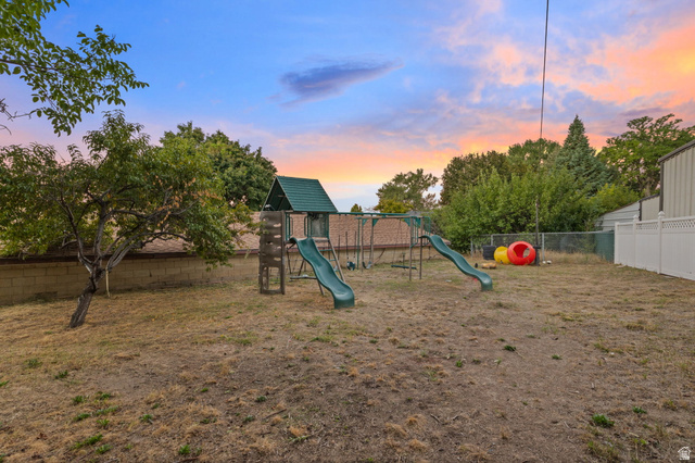 875 Cedar Hollow Road Lehi, UT 84043 - Photo 35 of 76 Expansive backyard featuring mature trees, a block wall, and a vinyl fence