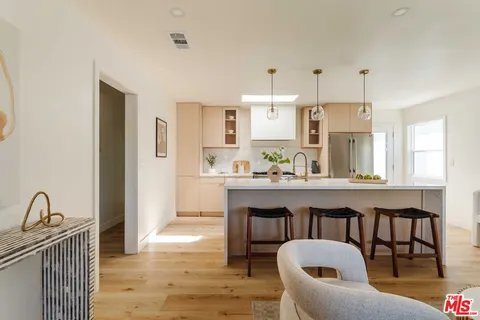 a kitchen with granite countertop white cabinets and stainless steel appliances
