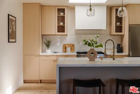 a kitchen with a sink and a refrigerator