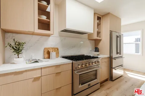 a kitchen with stainless steel appliances white cabinets and a stove