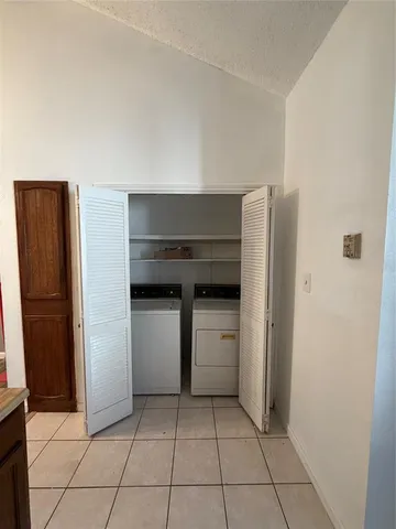 a kitchen with a refrigerator and cabinets