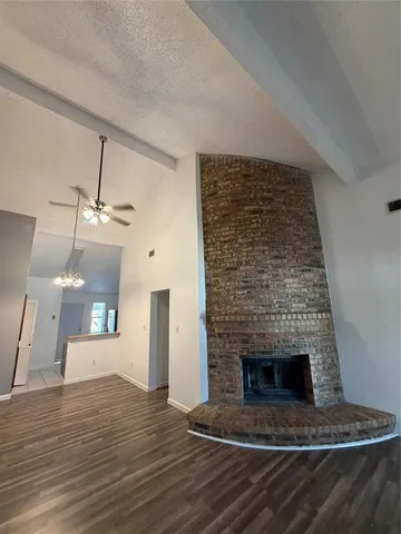 a living room with a fireplace and wooden floor