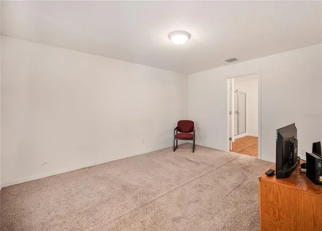 a view of room with window and a flat screen tv