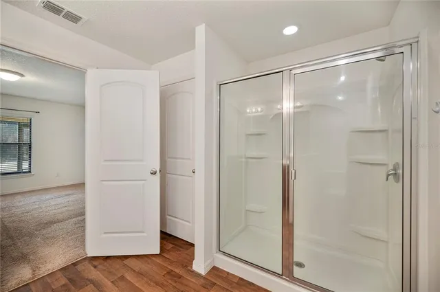 a view of a room with wooden floor