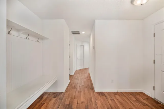 a view of hallway with wooden floor