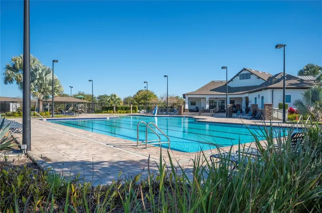a view of a patio with table and chairs potted plants