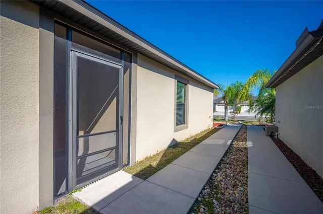 a kitchen with stainless steel appliances granite countertop a stove top oven a sink dishwasher and a refrigerator with wooden floor