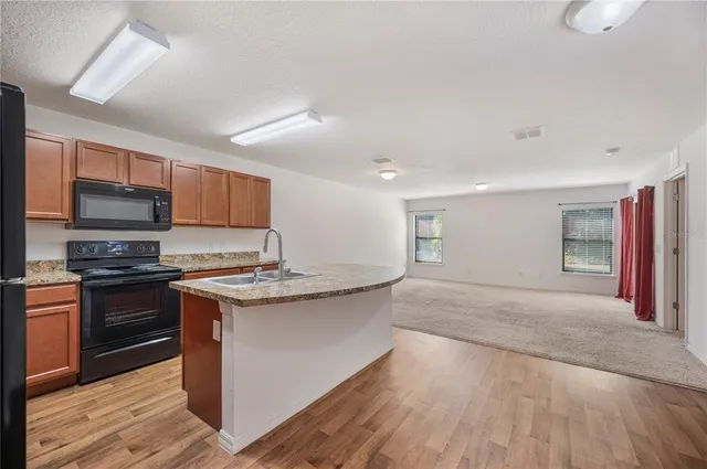 a kitchen with a refrigerator stove and microwave