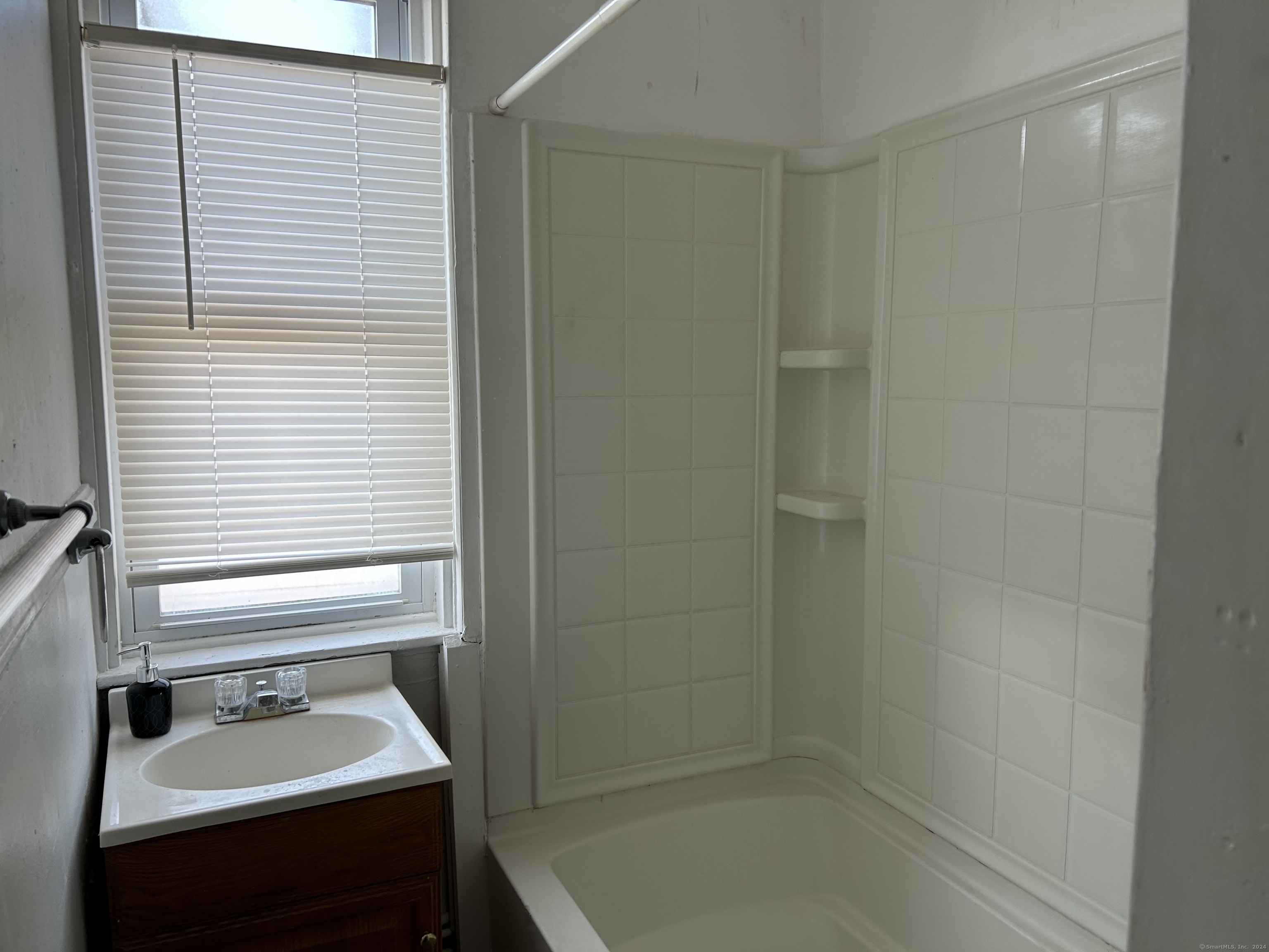 20 Beatty Street, Unit 3W New Britain, CT 06051 - Photo 2 of 15 a bathroom with a sink a bath tub and a window