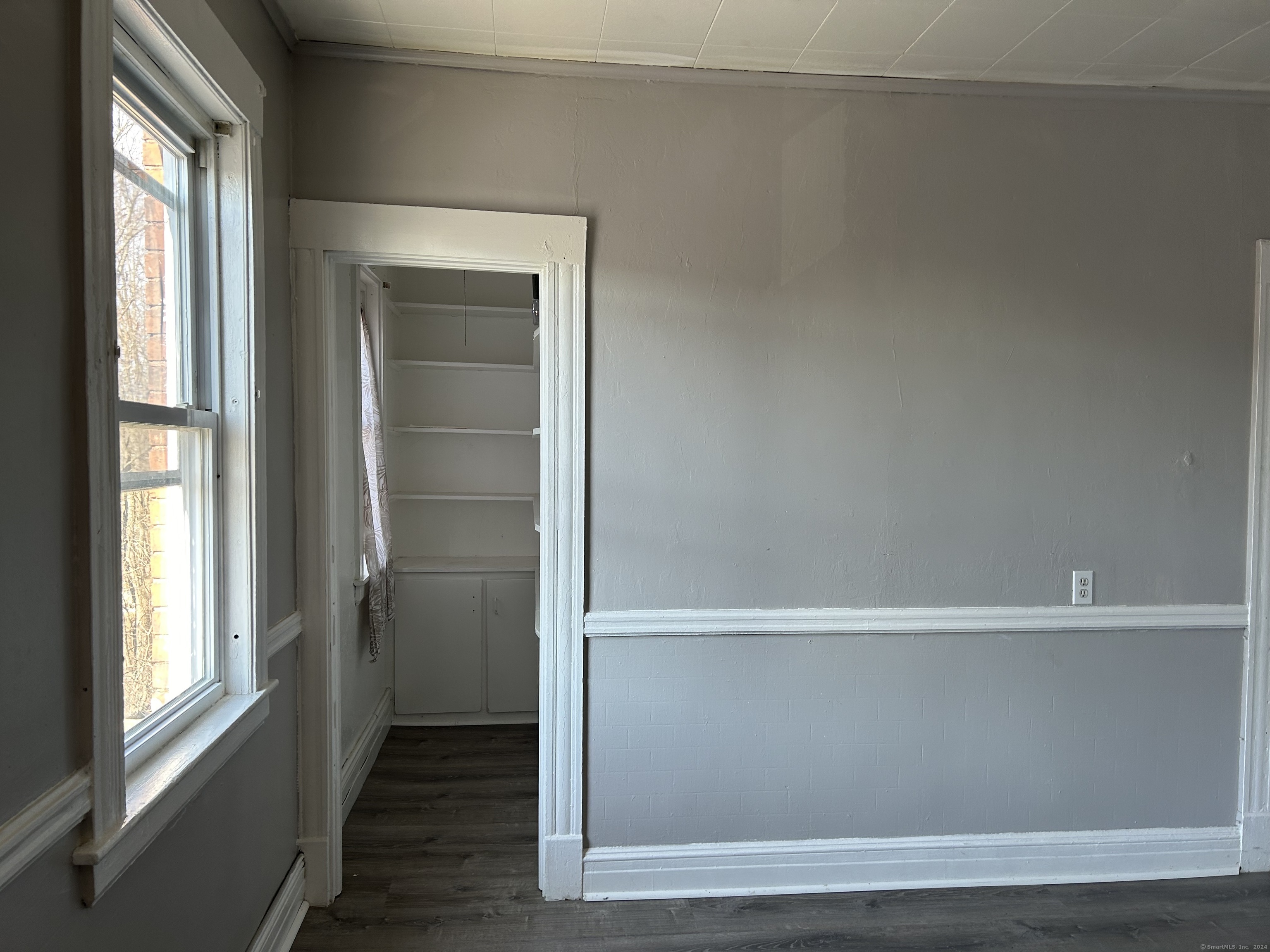 20 Beatty Street, Unit 3W New Britain, CT 06051 - Photo 5 of 15 a view of an empty room with wooden floor and a window