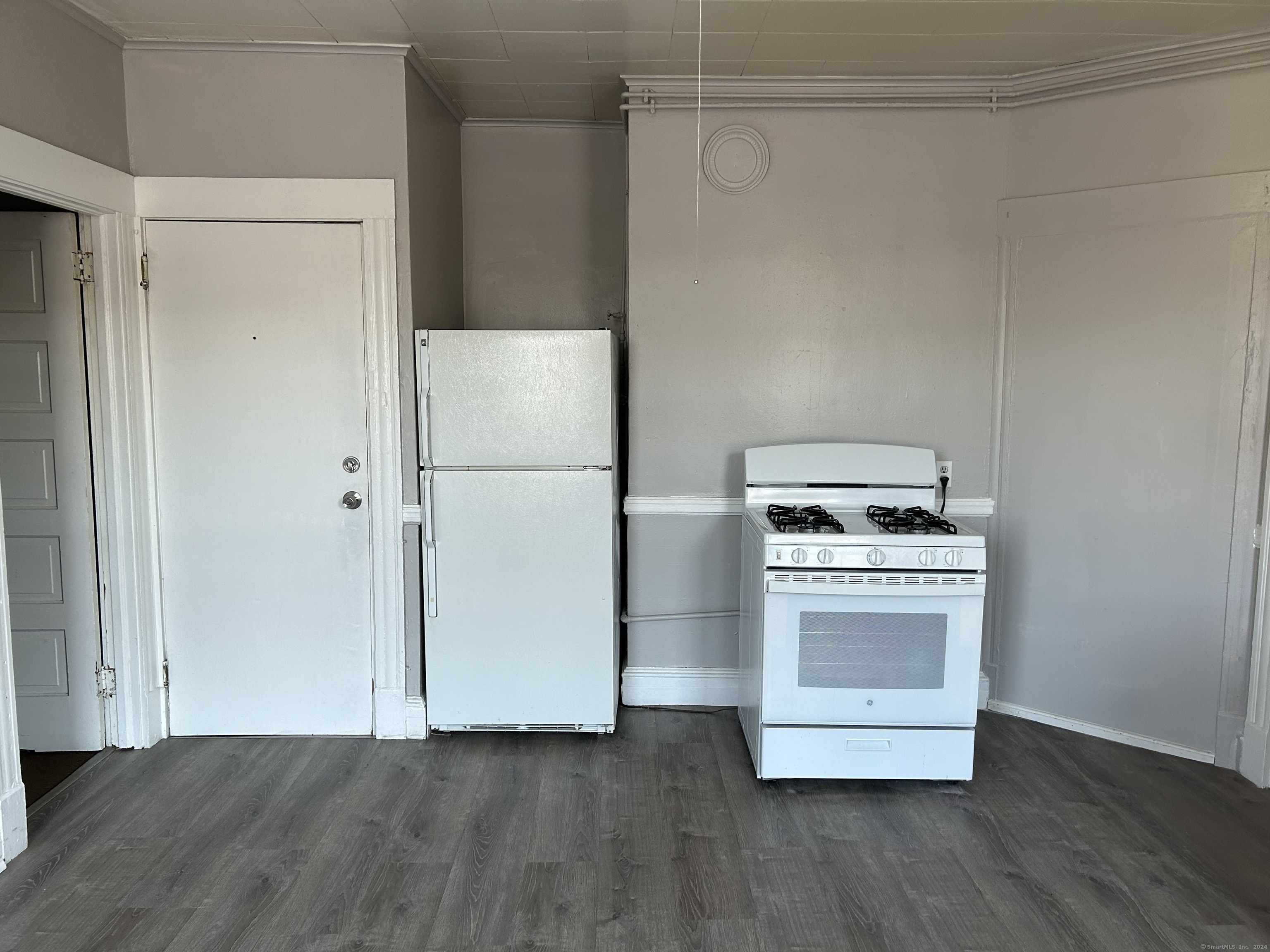 20 Beatty Street, Unit 3W New Britain, CT 06051 - Photo 6 of 15 a kitchen with a refrigerator and a stove top oven