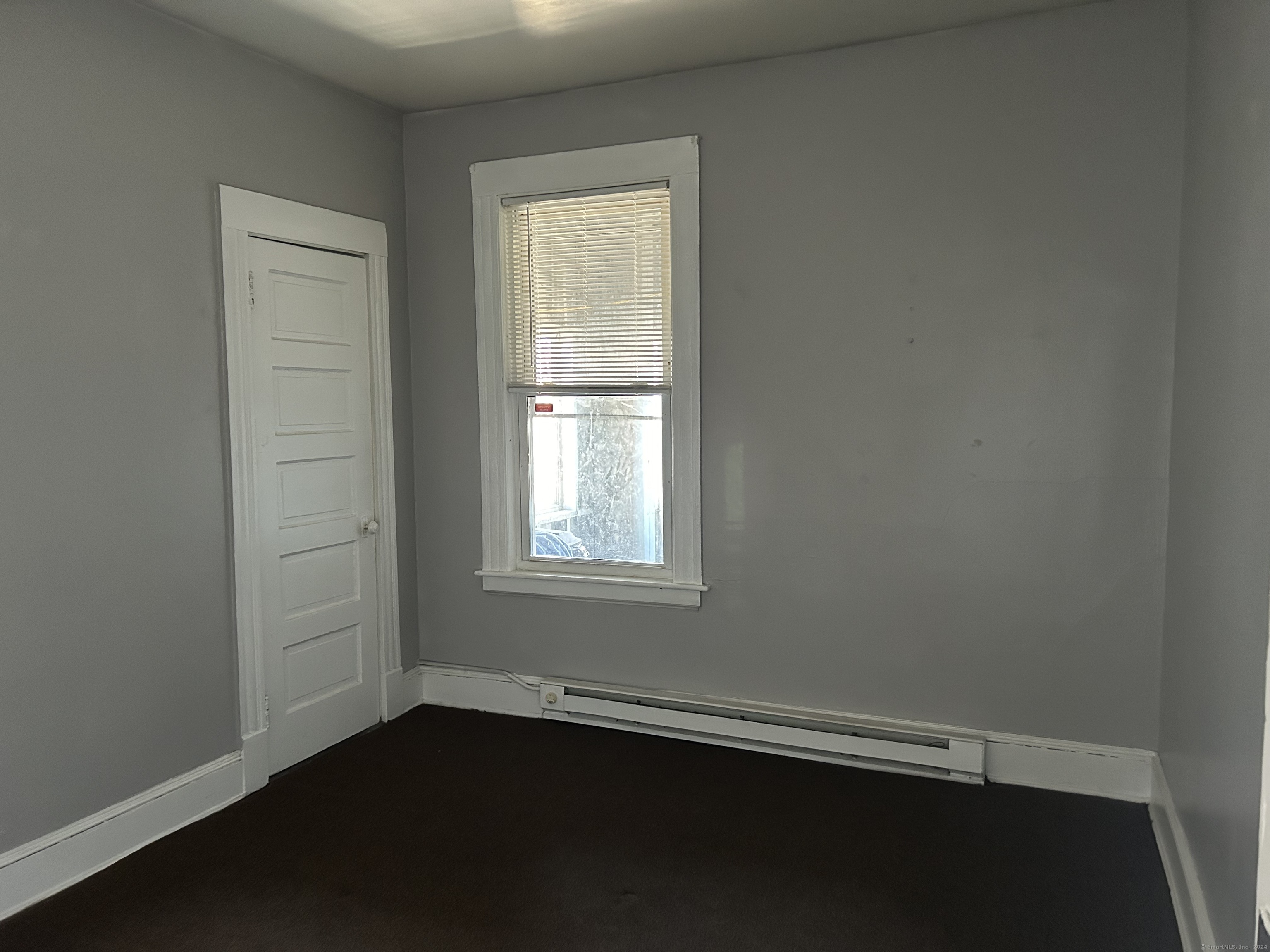 20 Beatty Street, Unit 3W New Britain, CT 06051 - Photo 7 of 15 an empty room with wooden floor and windows