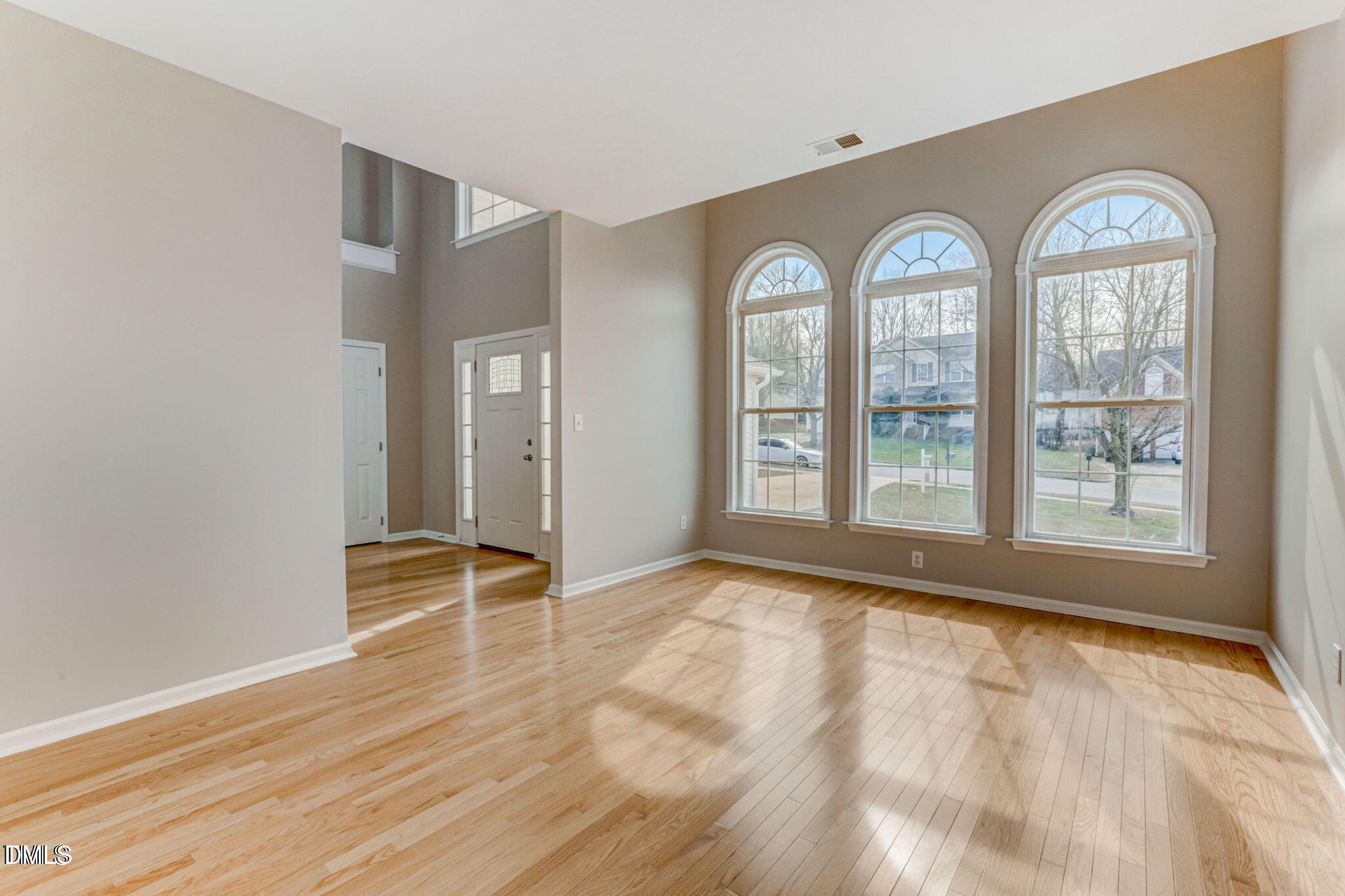 480 Seastone Street Raleigh, NC 27603 - Photo 8 of 26 an empty room with wooden floor and windows