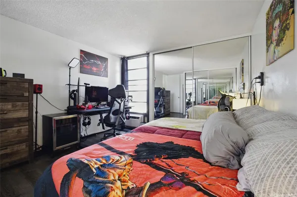 a bedroom with a bed and a flat screen tv
