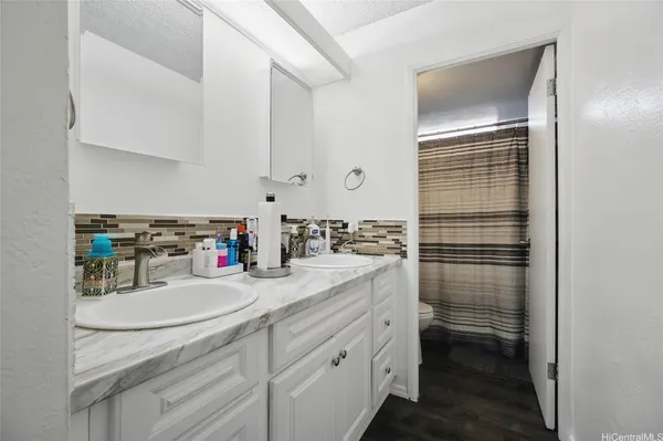 a kitchen with sink cabinets and stove