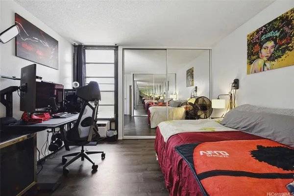 a bedroom with two bed and a desk