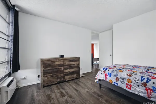 a bedroom with a bed and a dresser