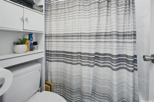 a bathroom with a granite countertop sink and a toilet