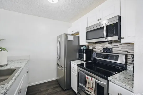 a kitchen with a stove microwave and sink