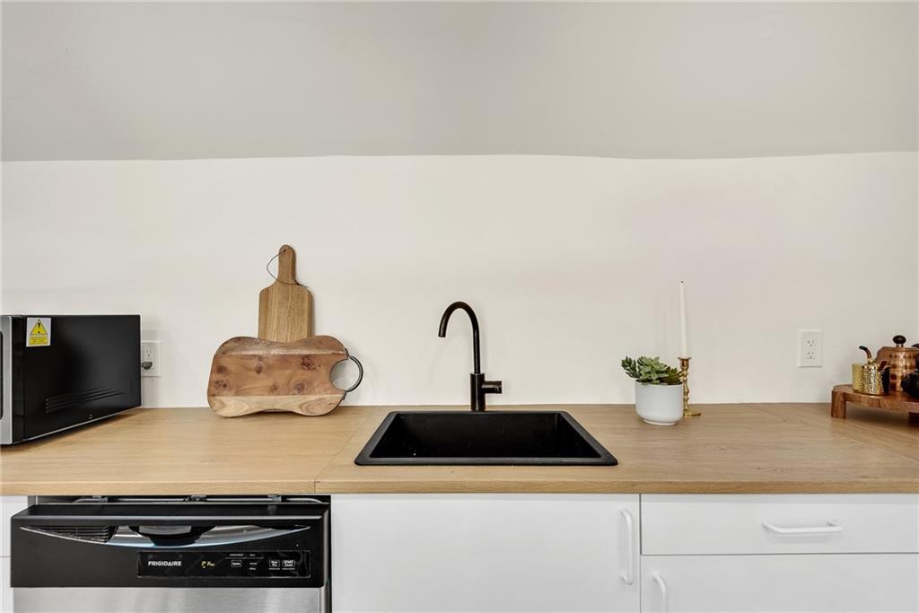 901 Argonne Avenue Northeast, Unit B Atlanta, GA 30309 - Photo 11 of 30 a kitchen with a sink and white cabinets