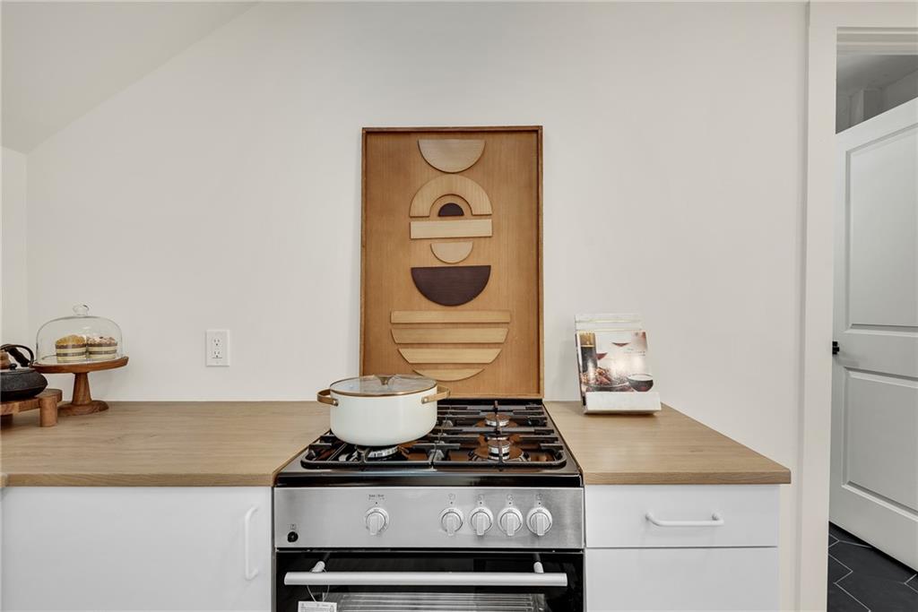 901 Argonne Avenue Northeast, Unit B Atlanta, GA 30309 - Photo 12 of 30 a stove top oven sitting inside of a kitchen