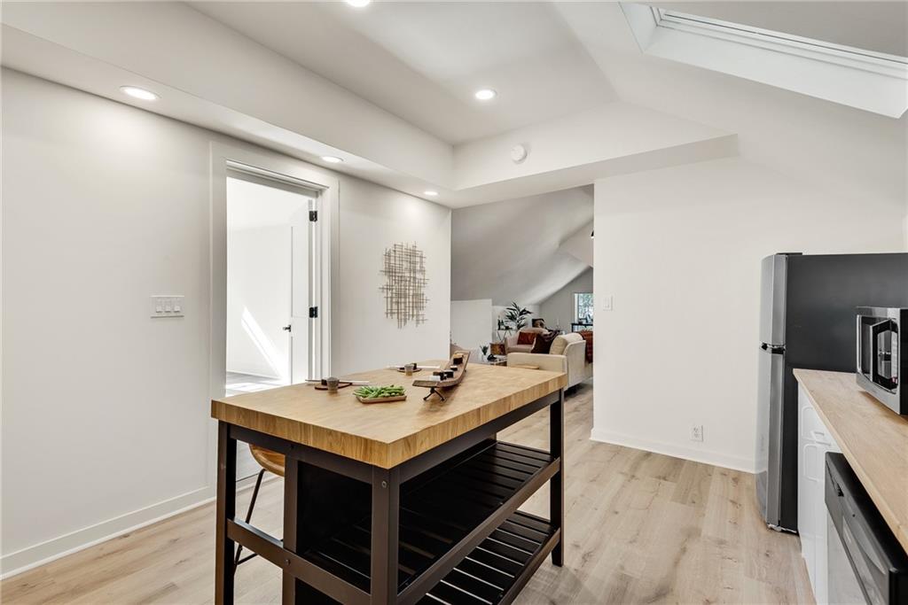 901 Argonne Avenue Northeast, Unit B Atlanta, GA 30309 - Photo 13 of 30 a kitchen with a sink cabinets and wooden floor