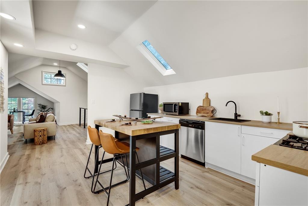 901 Argonne Avenue Northeast, Unit B Atlanta, GA 30309 - Photo 14 of 30 a view of a kitchen with cabinets and wooden floor