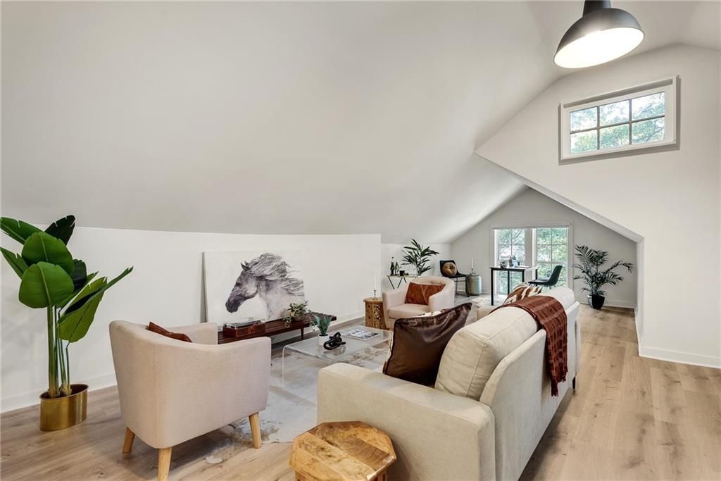 901 Argonne Avenue Northeast, Unit B Atlanta, GA 30309 - Photo 5 of 30 a living room with furniture and a potted plant