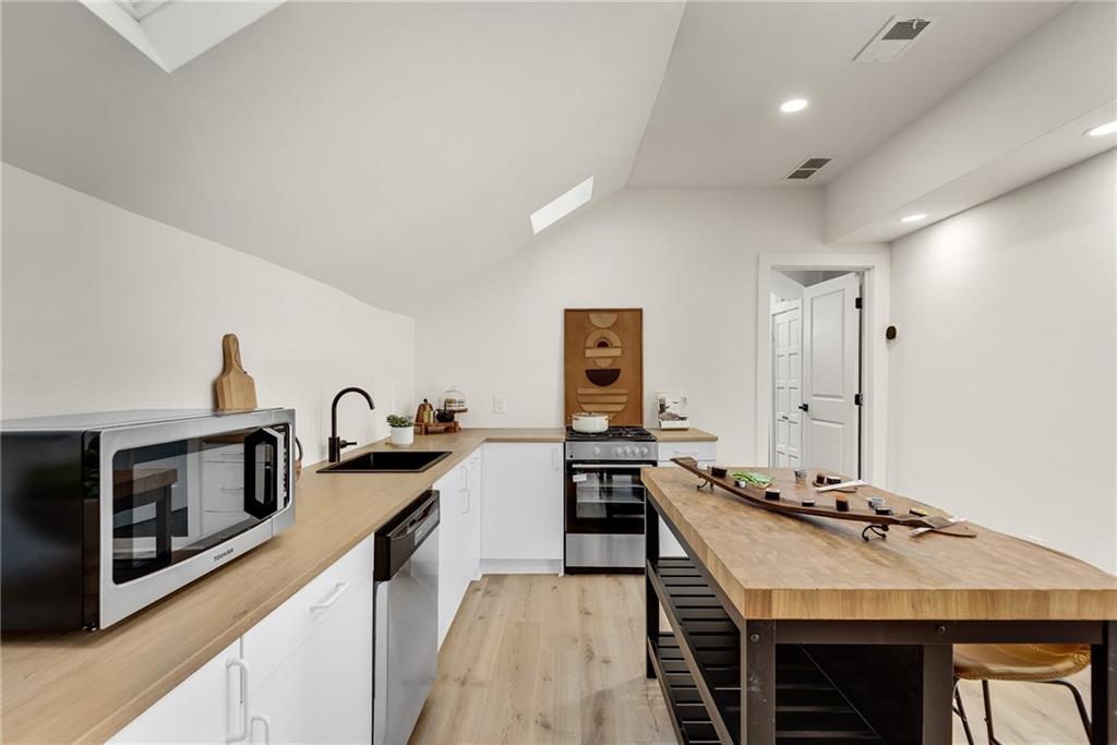 901 Argonne Avenue Northeast, Unit B Atlanta, GA 30309 - Photo 10 of 30 a kitchen with a sink stove and refrigerator