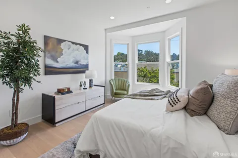 a bathroom with a sink a toilet and a large mirror
