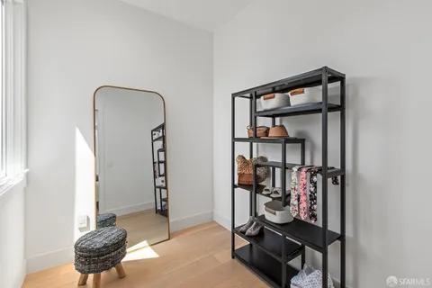 a bedroom with a bed a desk and chair