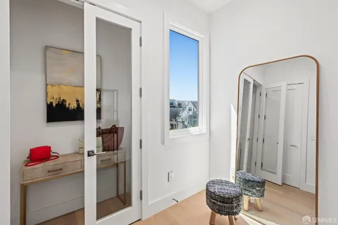 an aerial view of residential houses with outdoor space and trees