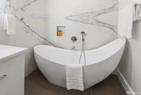 an aerial view of residential houses with outdoor space and ocean view