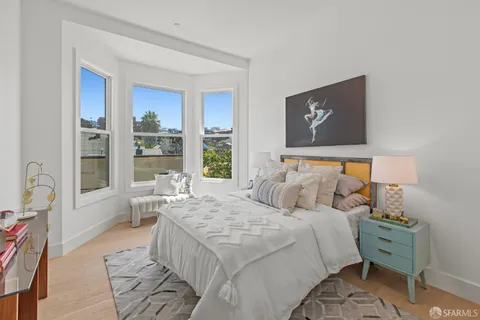 an aerial view of residential houses with a city view