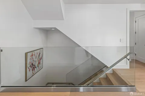 a kitchen with stainless steel appliances granite countertop a kitchen island a stove a dining table and chairs