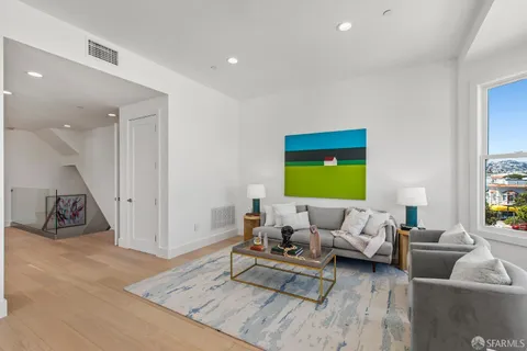 a kitchen with kitchen island granite countertop a refrigerator a sink a stove a microwave and wooden cabinets