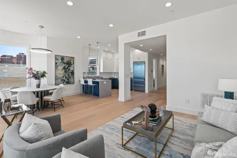 a bedroom with a large bed and a painting on the wall