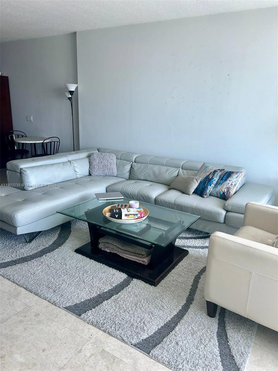 185 Southwest 7th Street, Unit 1802 Miami, FL 33130 - Photo 19 of 39 a living room with furniture and a rug