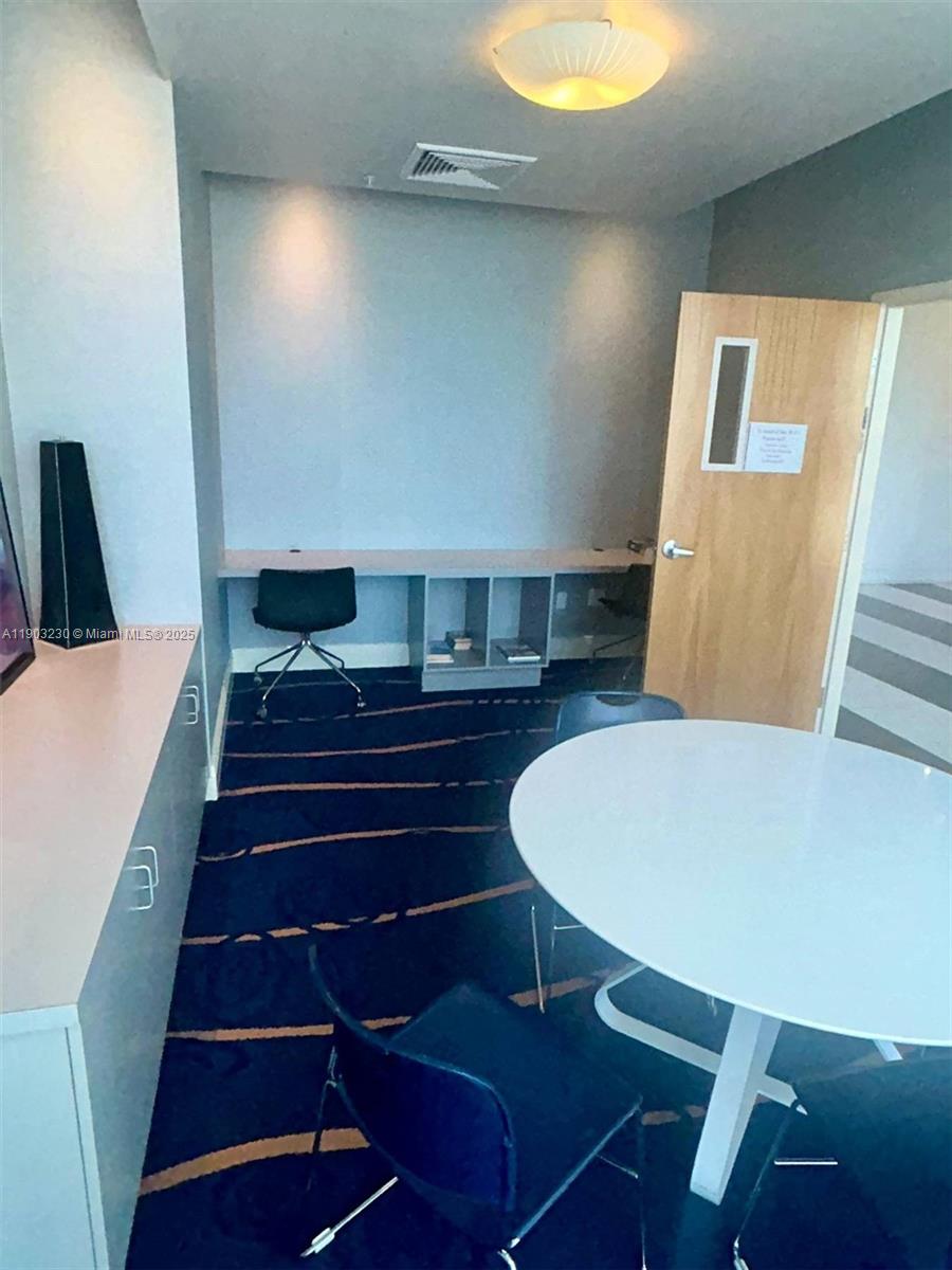 185 Southwest 7th Street, Unit 1802 Miami, FL 33130 - Photo 31 of 39 a living room with furniture and a wooden floor