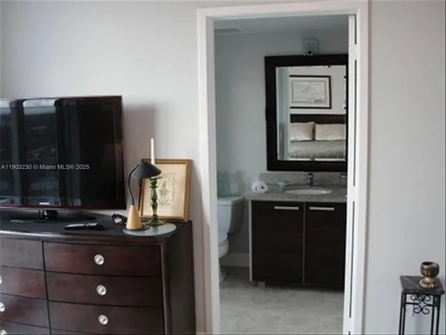 a room with a refrigerator and cabinets