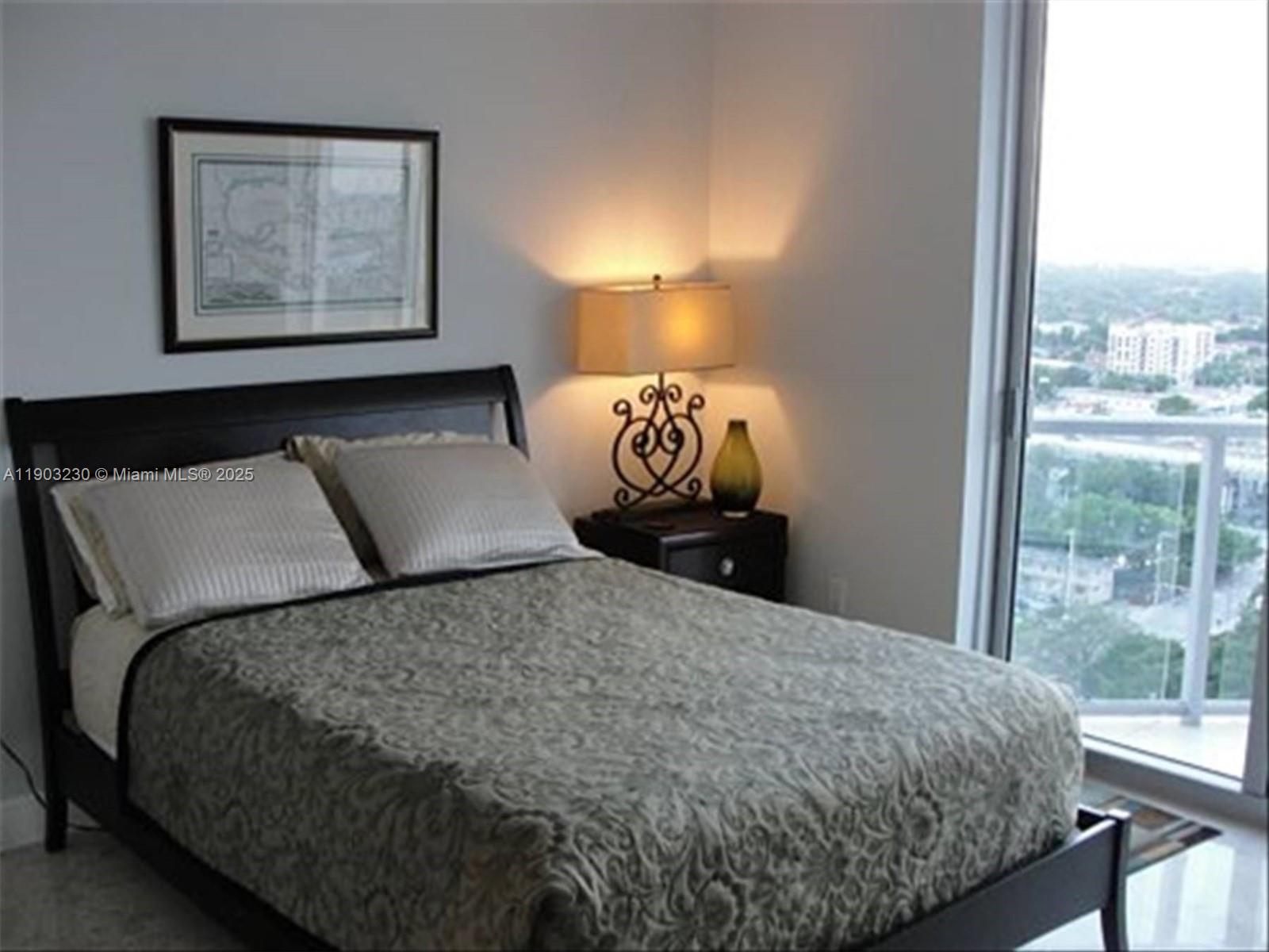 185 Southwest 7th Street, Unit 1802 Miami, FL 33130 - Photo 7 of 39 a bedroom with a bed and window