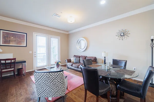 a living room with furniture a rug and a flat screen tv