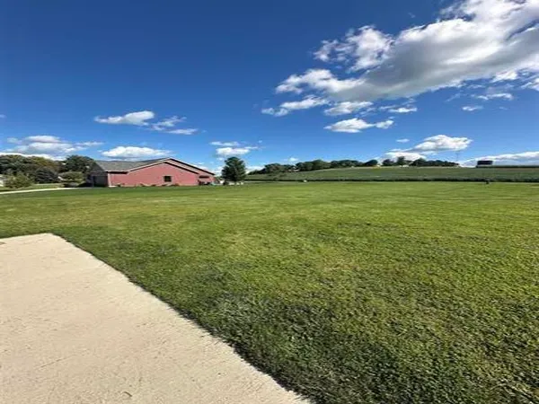 a view of a big yard with lots of green space and lake view